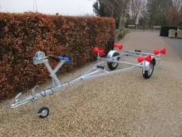 boottrailer op grindpad naast haag