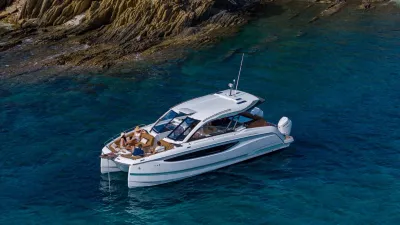 catamaran op blauw water bij rotsen