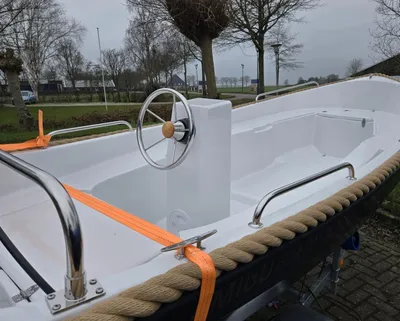 witte sloep op aanhanger buiten