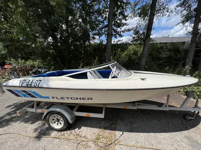snelboot op trailer bij bomen