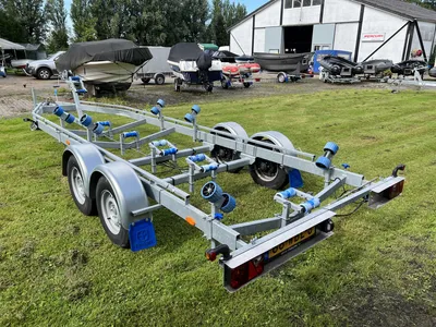 trailer op grasveld met boten op achtergrond