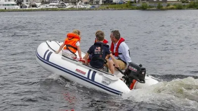 drie personen in een opblaasbare boot op het water