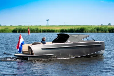 tender op rustig water met Nederlandse vlag