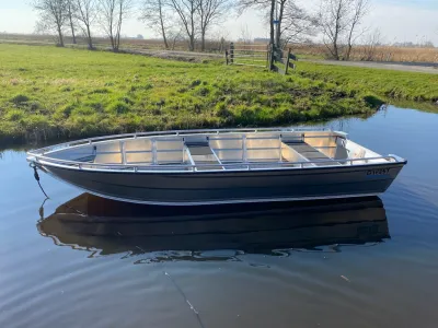 aluminium boot in kanaal bij grasland