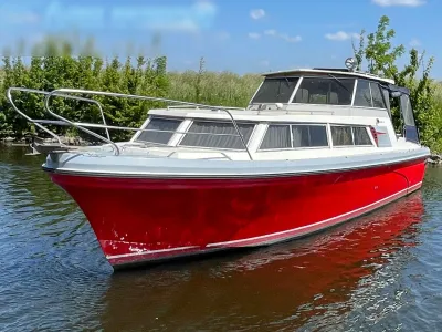 rood motorjacht afgemeerd op kanaal