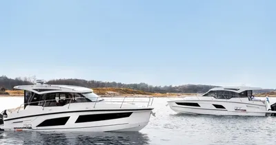 Twee motorjachten op rustig water bij de kust