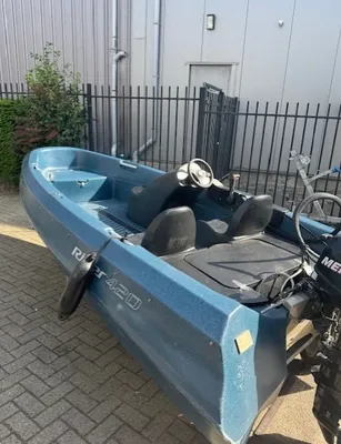 kunststof boot op oprit bij hek