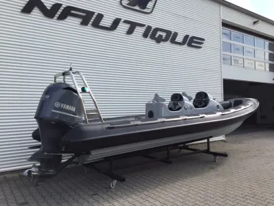 grijze RIB-boot op bok voor bedrijfsgebouw