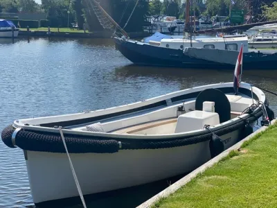 Witte sloep afgemeerd aan kade