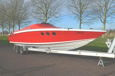 rode sportboot op trailer bij bomen