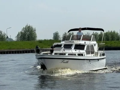 wit motorjacht op kanaal