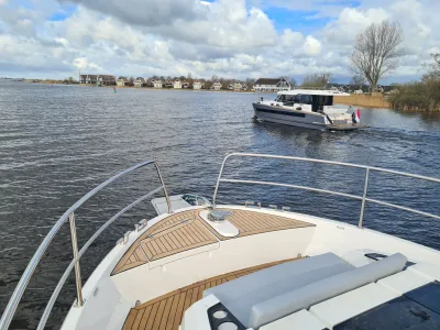 voordek van motorjacht met water en huizen