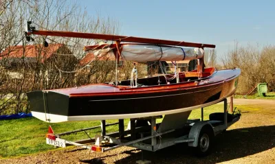 houten zeilboot op trailer op verkoopterrein