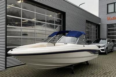 Witte motorboot buiten voor bedrijfsgebouw