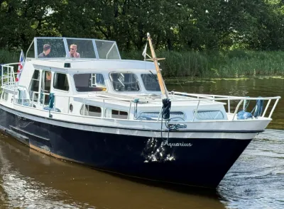 witte motorcruiser op rivier met bemanning