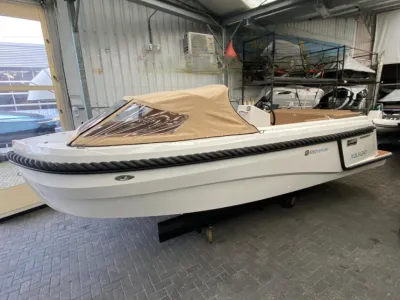 sloep in loods met opgevouwen buiskap