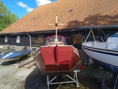 rode schouw op bokken voor houten loods