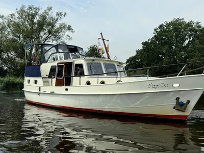 motorjacht op rivier met bomen op achtergrond