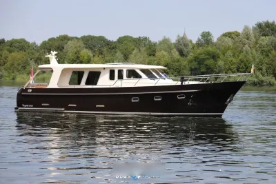 motorjacht op stil water bij groene oever