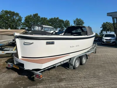 witte boot op trailer op bestrating