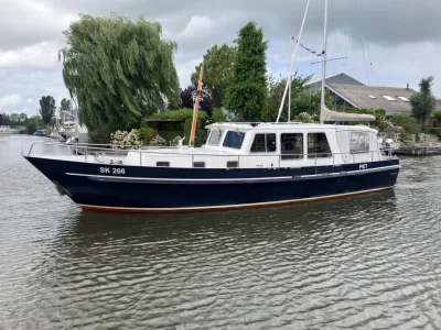 motorjacht op water met kade en bomen
