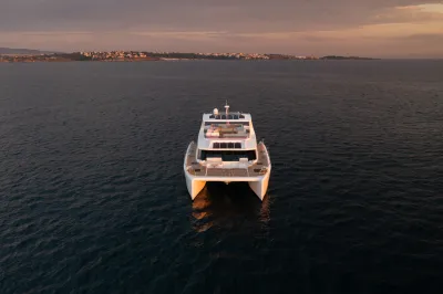 motorcatamaran op zee bij zonsondergang