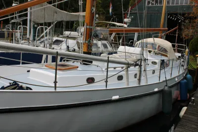 zeiljacht aangemeerd bij steiger, dek en reling zichtbaar