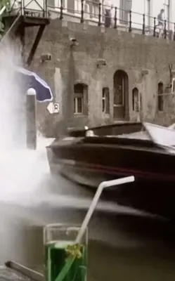 snelle boot in gracht met drank op voorgrond