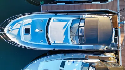 bovenaanzicht van motorjacht aan een steiger