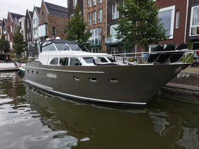 motorjacht aangemeerd bij kanaal en woonhuizen