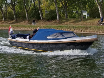 motorvlet met blauwe kuiptent op kanaal