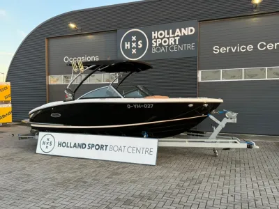 zwarte sportboot op trailer voor bedrijfspand