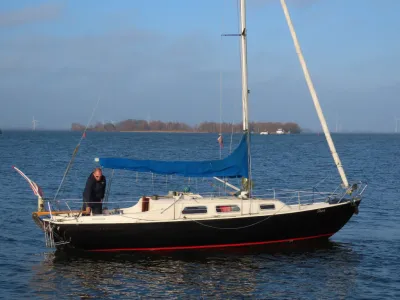 zeiljacht op het water met persoon aan dek