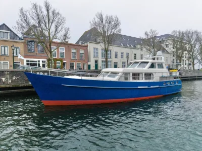 blauwe kotter afgemeerd bij kade