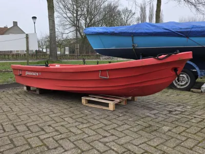 rood kunststof bootje op parkeerplaats