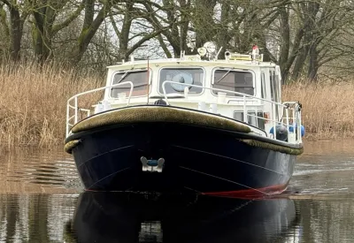 vlet vooraan op water met riet op achtergrond