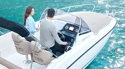 twee personen op voordek van motorboot