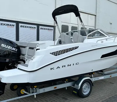 Witte motorboot op trailer bij gebouw