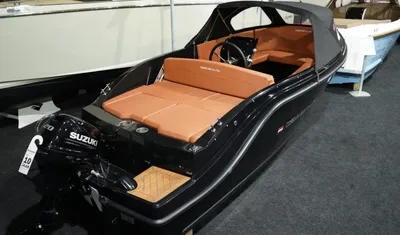 zwarte sloep met bruin interieur in showroom