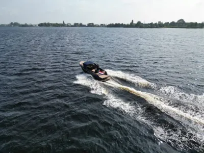 sloep op open water met wake