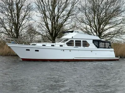 wit motorjacht in profiel op rivier