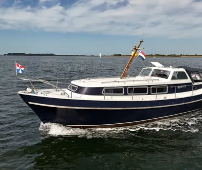 motorjacht op open water met vlaggen