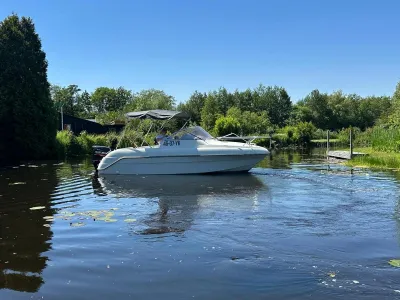 witte motorboot op kanaal bij zonnig weer