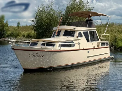 motorjacht op rustig water bij oever