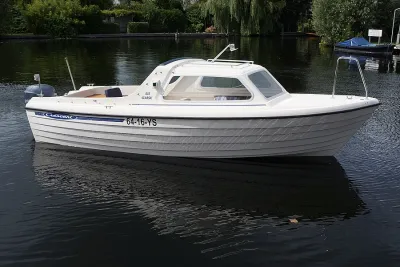 witte motorboot met gesloten kajuit
