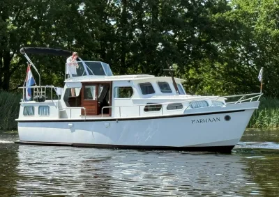 witte motorcruiser op water met bomen