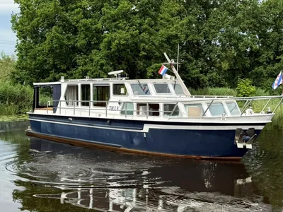 motorjacht op rustig water met bomen op achtergrond