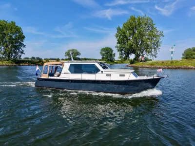 motorjacht op rivier met bomen en blauwe lucht