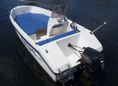 consoleboot met blauwe kussens op water