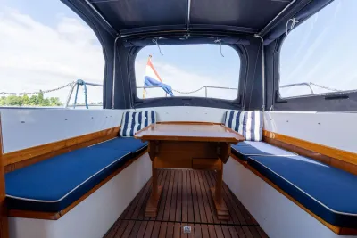 kuip van motorjacht met tafel en kussens